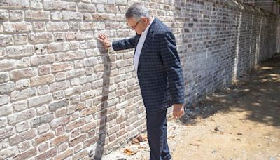 Brick wall at Second Presbyterian Church that collapsed now is rebuilt. Sidewalk is next.