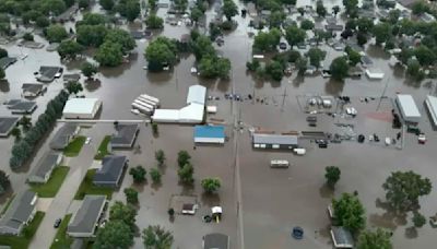 Flooding forces people from homes in some parts of Iowa while much of US toils again in heat