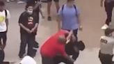 Video shows a father in a fistfight with students during a high school mass brawl started by his son's love triangle