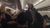 Passengers erupt into 'cheerio' chant after rowdy couple removed from flight