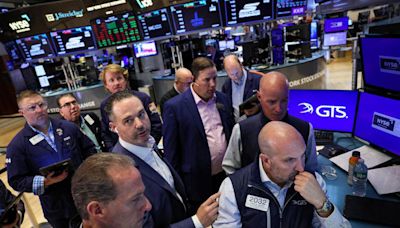 Wall Street slips as markets juggle data, technical glitches