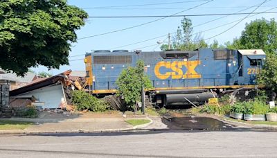 CSX train derails off tracks, crashing into home's garage