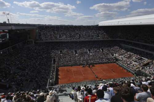 Olympic tennis players return to the red clay of Paris’ Roland Garros after Wimbledon’s grass