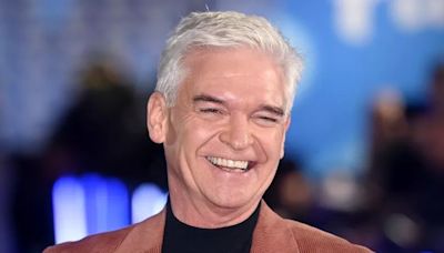 Smiley Phillip Schofield spotted with wife and daughters as they arrive at Grand Prix in style