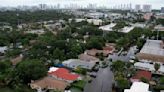 Tropical rainstorms in South Florida lead to flight delays and streets jammed with stalled cars