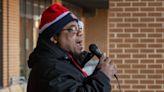 Salvation Army bell ringer sings while he rings in Westborough