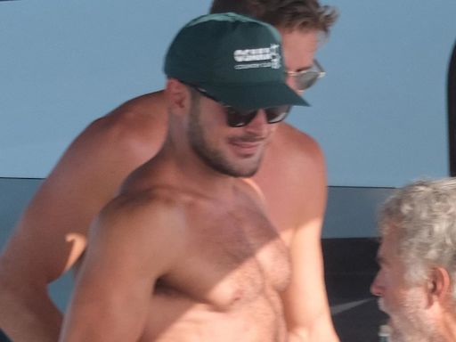 Zac Efron bares his chiseled chest as he goes shirtless on a yacht