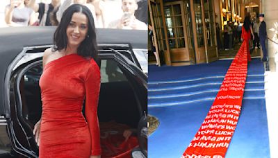 Katy Perry Redefines Statement Dressing in Fiery Red Balenciaga Dress With a Never-ending Train Featuring the Lyrics of Her New...