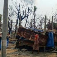 A woman walks past her temporary house following fighting between Myanmar's military and the Arakan Army