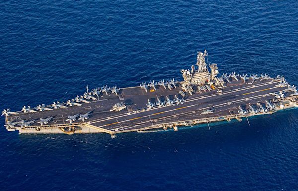 The US Navy carrier strike group fighting off Houthi missiles is staying in the Red Sea for now