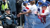 French children hail D-Day veterans as heroes as they arrive in Normandy for anniversary events