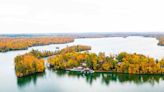 This 12-acre Private Lake Island in the Midwest Is Perfect for a Summer Getaway — With a 23-room Lodge and Cozy Cabins