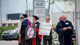 Around 30 IU faculty silently protest outside graduate commencement Friday