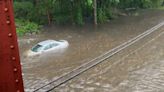Downpours flood highways, city streets