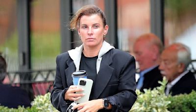 Coleen Rooney wears an oversized blazer and gym wear