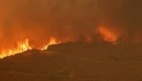 A house is threatened as the Airport Fire gains ground near Lake Elsinore