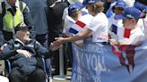 French children hail D-Day veterans as heroes as they arrive in Normandy for anniversary events