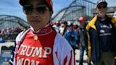 Pick-up trucks and Jeep off-roaders adorned with giant Trump flags and banners denouncing Biden patrolled the coast road beside the rally site