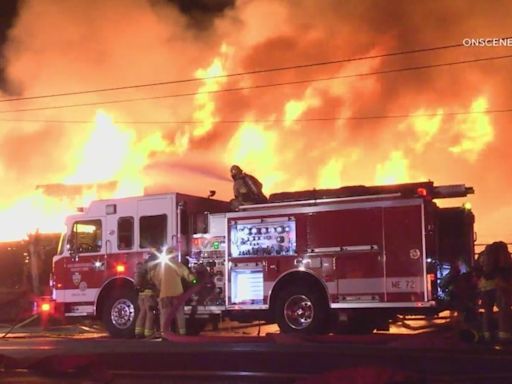 Firefighter injured after blaze torches stacked pallets, vehicles, trucks and trailers