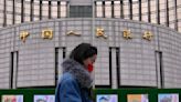 China's central bank cuts interest rates, moving to put more pep into the economy