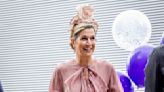 Queen Maxima of the Netherlands Opts for Whimsical Dressing in Playful Dusty Rose Dress and Floral Hat at Amsterdam College