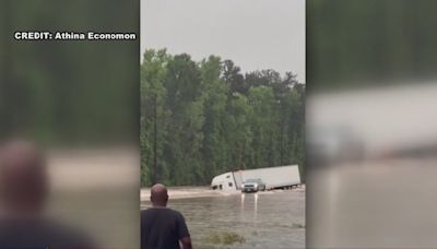 When all you see is truck top, it's time to go! Game Wardens helping families evacuate floodwaters