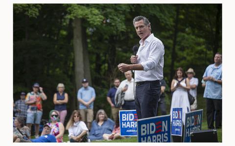 California Gov. Gavin Newsom says Michigan stop shows he’s ‘all in’ for Biden