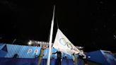 Olympic flag raised upside down at end of rain-soaked opening ceremony