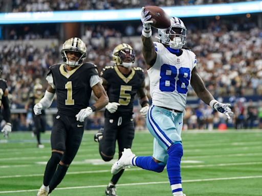 Cowboys' CeeDee Lamb ducks under Saints' would-be tacklers on a 65-yard TD