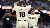 The San Francisco Giants' Mike Yastrzemski is congratulated by teammate Curt Casali after he hit a two-run home run against the Los Angeles Dodgers in the third inning...