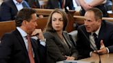 ... Police Officer John O'Keefe, talks with her attorney's Alan Jackson and David Yannetti as she attends a hearing in Norfolk Superior Court...