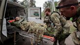 Military paramedics treat a wounded Ukrainian service member near the town of Vovchansk