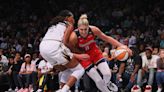 Basketball star Elena Delle Donne signing bottles of her wine Friday in Wilmington