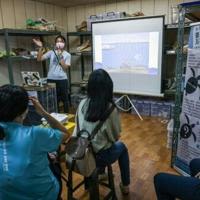 Volunteers attend a lecture by the Taiwan Cetacean Society to learn about the right way to rescue stranded whales