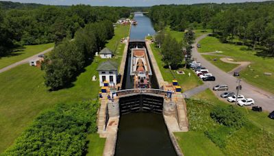 Where to see the barge carrying a pedestrian bridge on the Erie Canal near Rochester