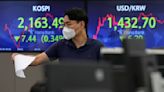 Asian stocks sink on German inflation, British tax cuts