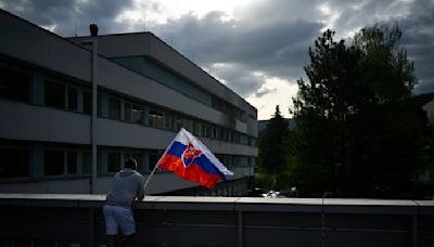 Suspect in shooting of Slovak prime minister is escorted to his home as police search for evidence