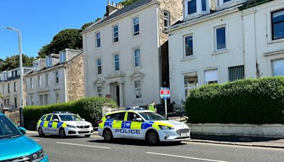 Police officers carry out door-to-door enquiries in Gourock