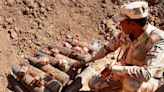 Here's how some Iraqis help dig up and disable thousands of bombs that are still buried in Iraq after the war with ISIS