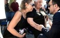 Cypriot President Nikos Christodoulides (R) talks with the widow of a soldier killed in the 1974 Turkish invasion of Cyprus, at Makedonitissa military cemetery in Nicosia,