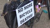 On a gloomy, rainy evening, cyclists ride in silence to remember those who have died