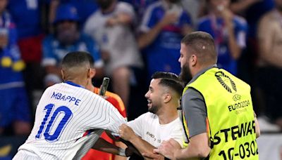 Pitch invader grabs Kylian Mbappe during Spain v France quarter-final at Euro 2024