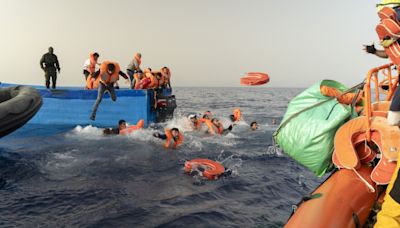 Migrants jump into sea as armed bandits climb onboard their boat during rescue mission