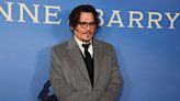 Johnny Depp Embraces His Co-Star in Rare Red Carpet Appearance