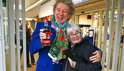 Rod Stewart shares a smooch with fan outside Tesco as they take a drink of his whisky