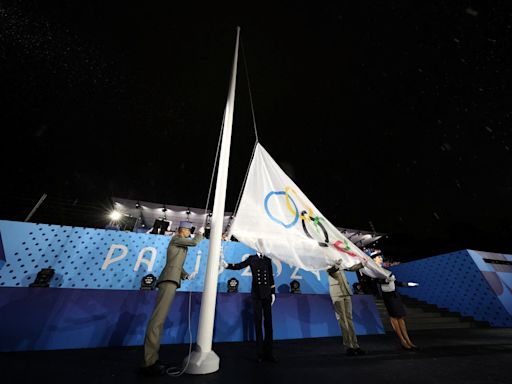 Olympic flag raised upside down at end of rain-soaked opening ceremony