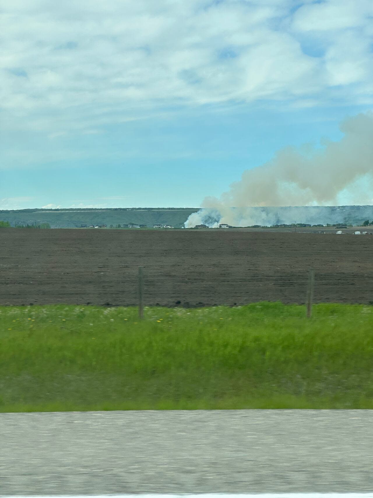 Grass fire in Springbank extinguished after threatening nearby community