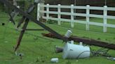 Storms with strong winds leave behind snapped power poles and trees in Edmond