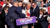 Donald Trump falls to ground bleeding after gun attack at rally