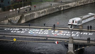 Aktivisten pinseln riesige Botschaft auf eine Berliner Brücke